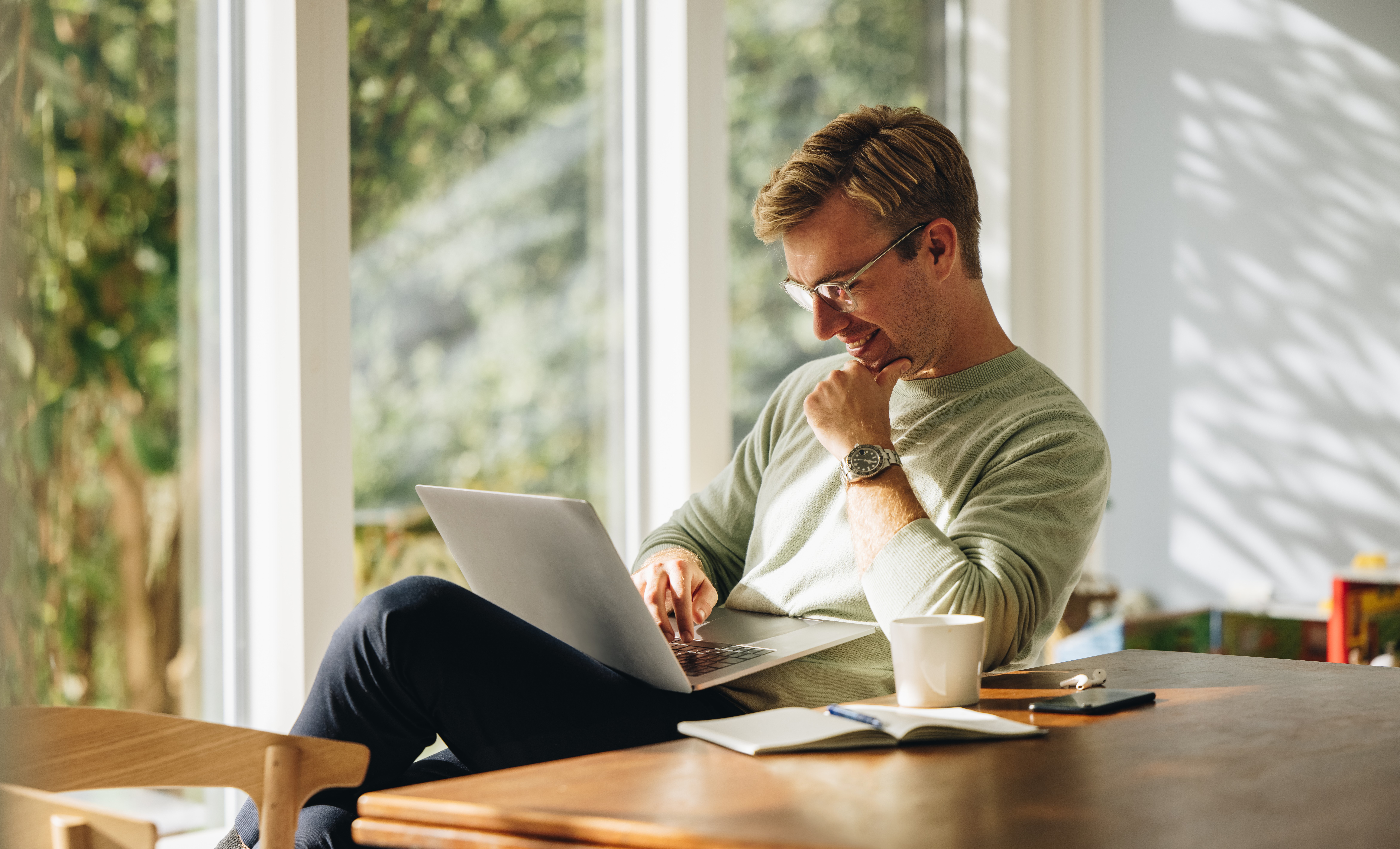 Professional working on a laptop at a desk, representing analysis and management of customer engagement or digital wallet program performance.