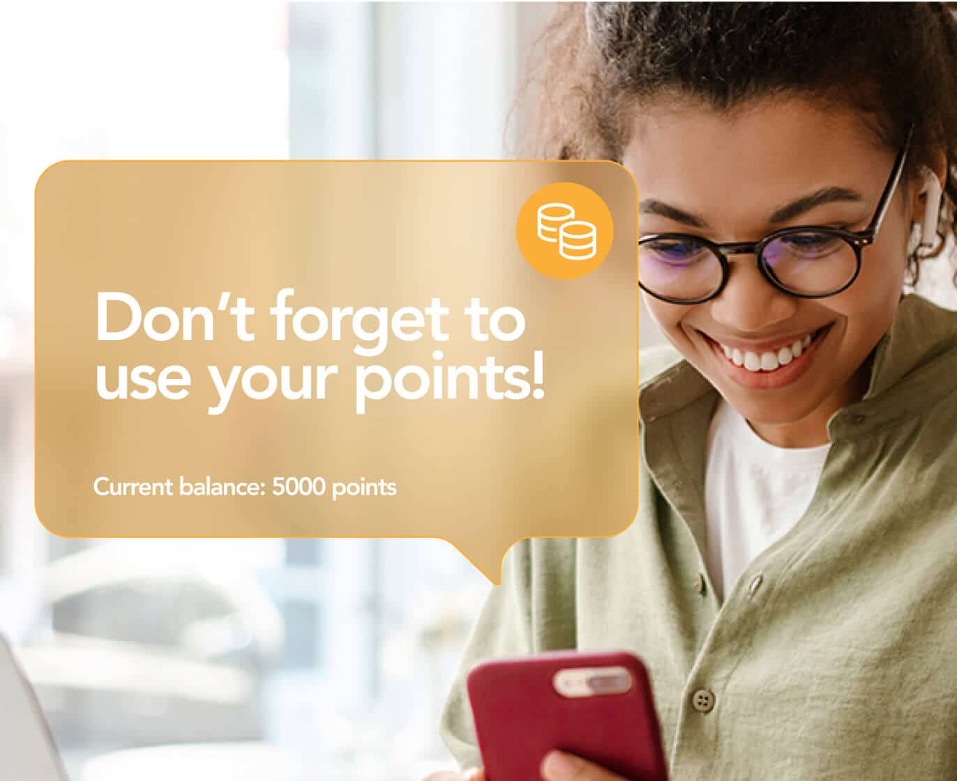 Customer smiling while viewing a mobile wallet notification reminding them to use their loyalty points, showing a current balance of 5,000 points on their phone.