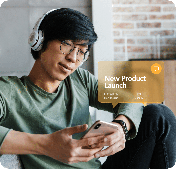 Customer using a smartphone while receiving a mobile wallet notification about a product launch, including location and date details for timely engagement.