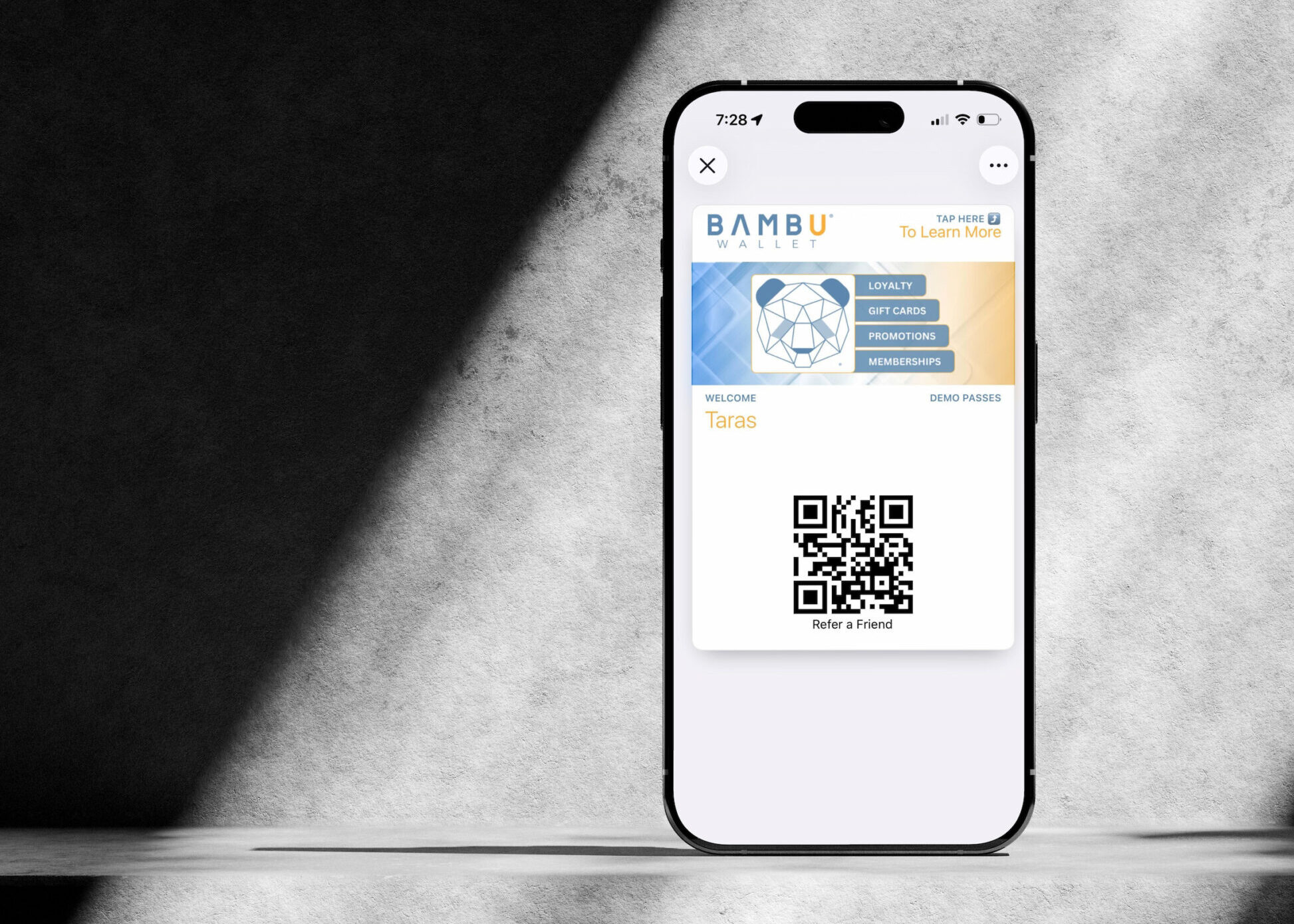 Smartphone displaying a Bambu Wallet digital pass with QR code on screen, illustrating mobile wallet engagement and customer interaction through Apple Wallet or Google Wallet passes.