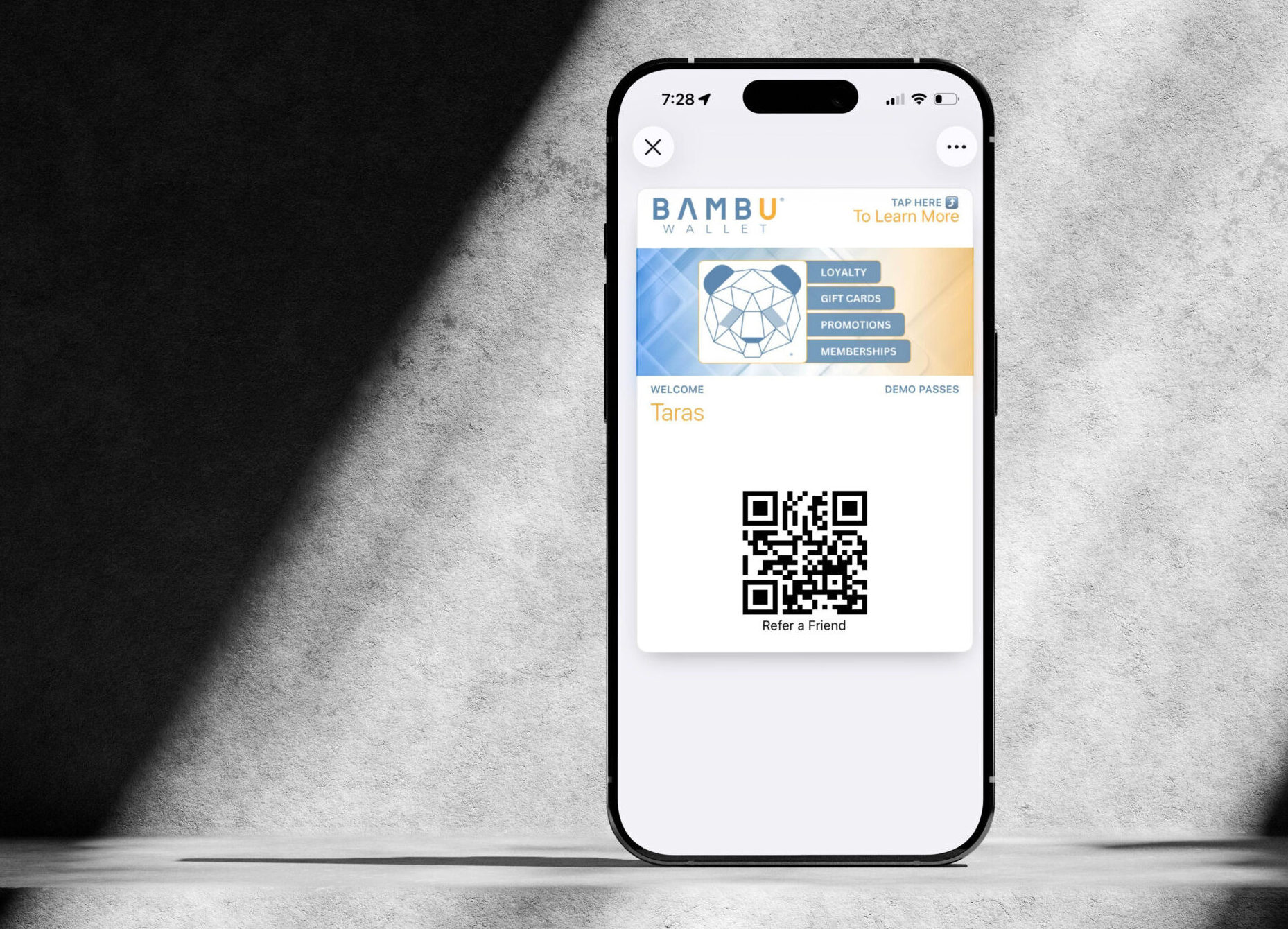 Smartphone displaying a Bambu Wallet digital pass with QR code on screen, illustrating mobile wallet engagement and customer interaction through Apple Wallet or Google Wallet passes.